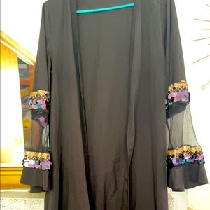 Black abaya with sequins work in hand.